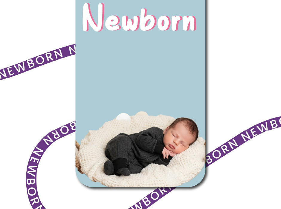 Newborn baby in a black outfit lying on a white blanket with 'Newborn' text above.